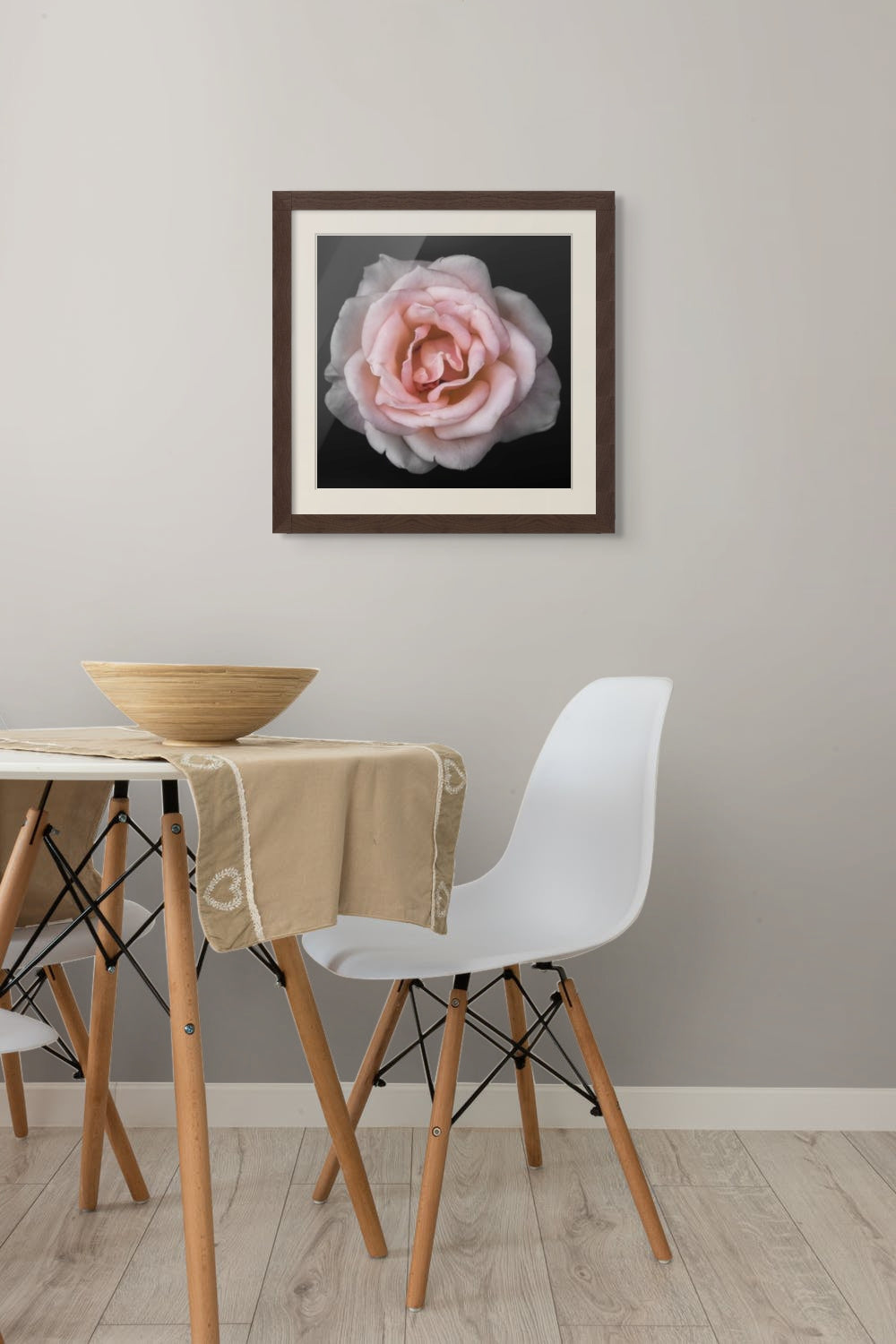 Framed fine art pink rose on wall in dining area